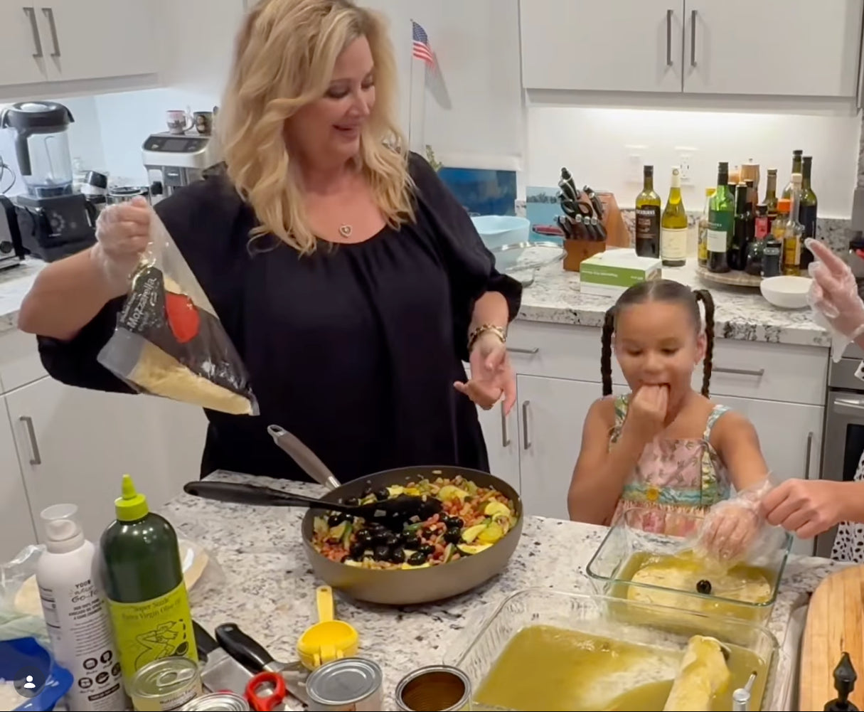 Woman and child in a kitchen preparing food together.