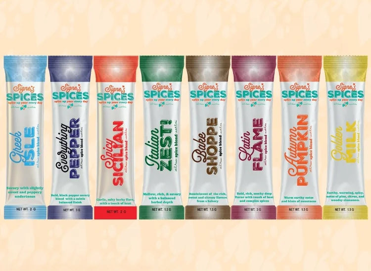 Row of spice packets with colorful labels on a beige background